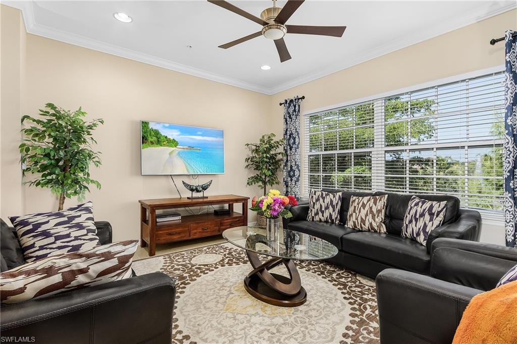 23550 Alamanda Drive, Unit 202 Estero, FL 34135 - Photo 8 of 26 a living room with furniture and a window
