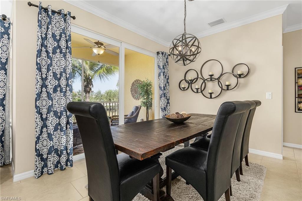 23550 Alamanda Drive, Unit 202 Estero, FL 34135 - Photo 9 of 26 a view of a dining room with furniture and window