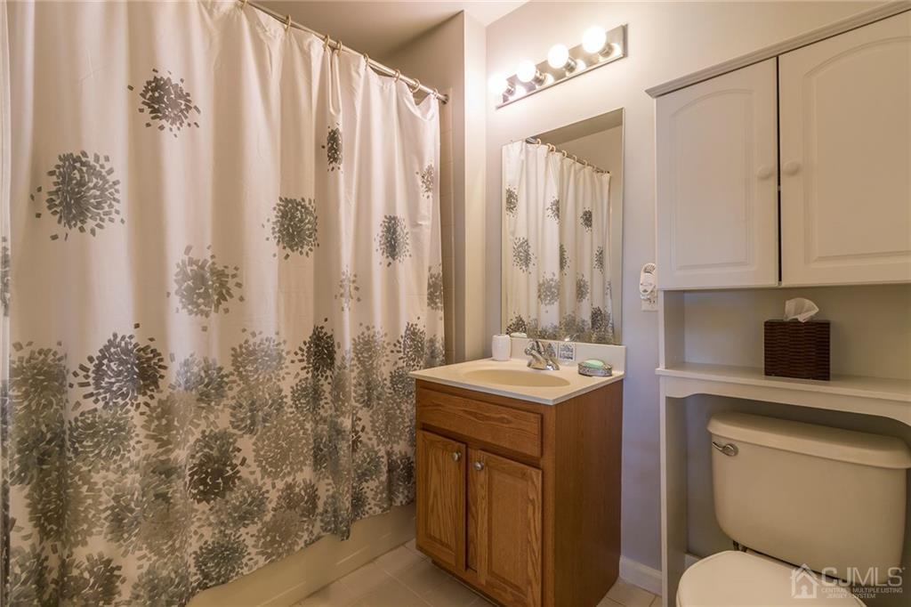 358 Rector Street, Unit 222 Perth Amboy, NJ 08861 - Photo 17 of 25 a bathroom with a toilet sink and mirror