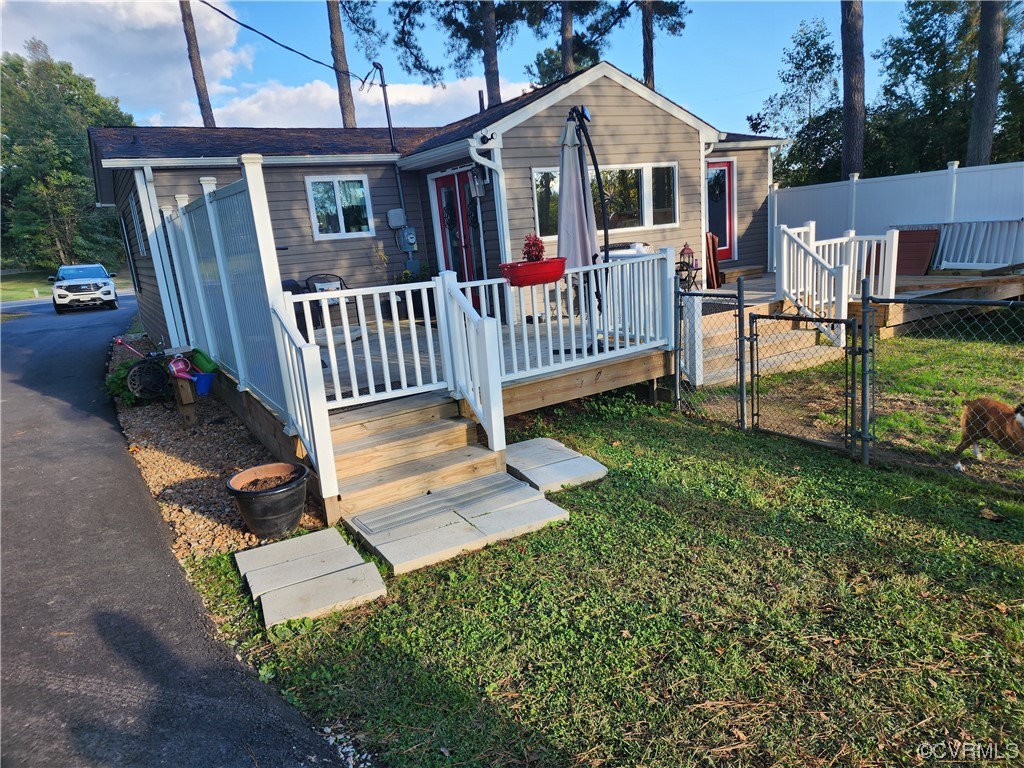 16820 Courthouse Road Dinwiddie, VA 23841 - Photo 2 of 10 a view of a house with a yard and deck