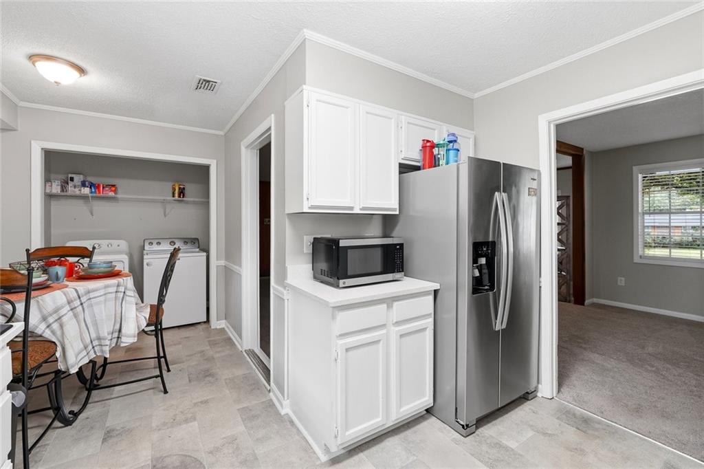 1619 Ridgeview Drive Northwest Conyers, GA 30012 - Photo 8 of 20 a kitchen with a refrigerator a stove and a dining table