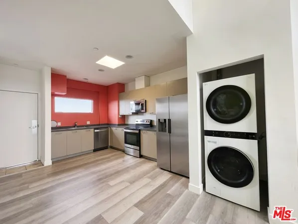 a view of a kitchen with a stove top oven and refrigerator