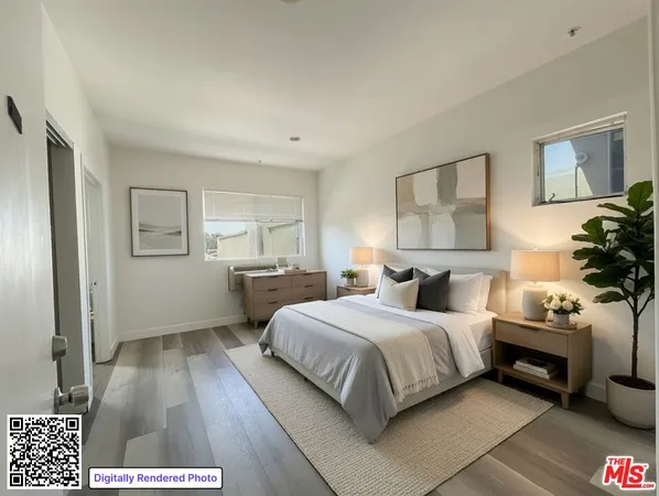 a bedroom with a bed and a potted plant