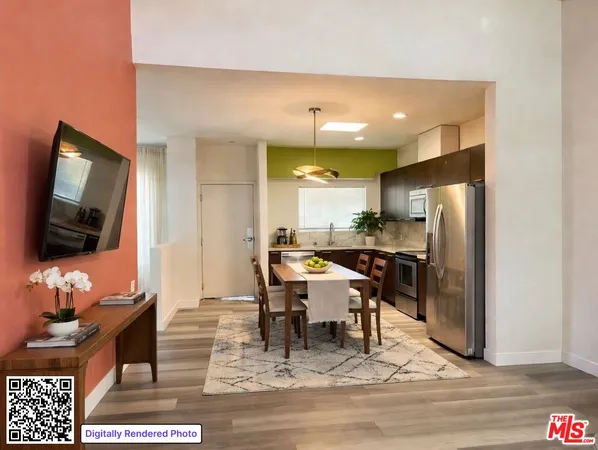 a living room with a flat screen tv and kitchen view