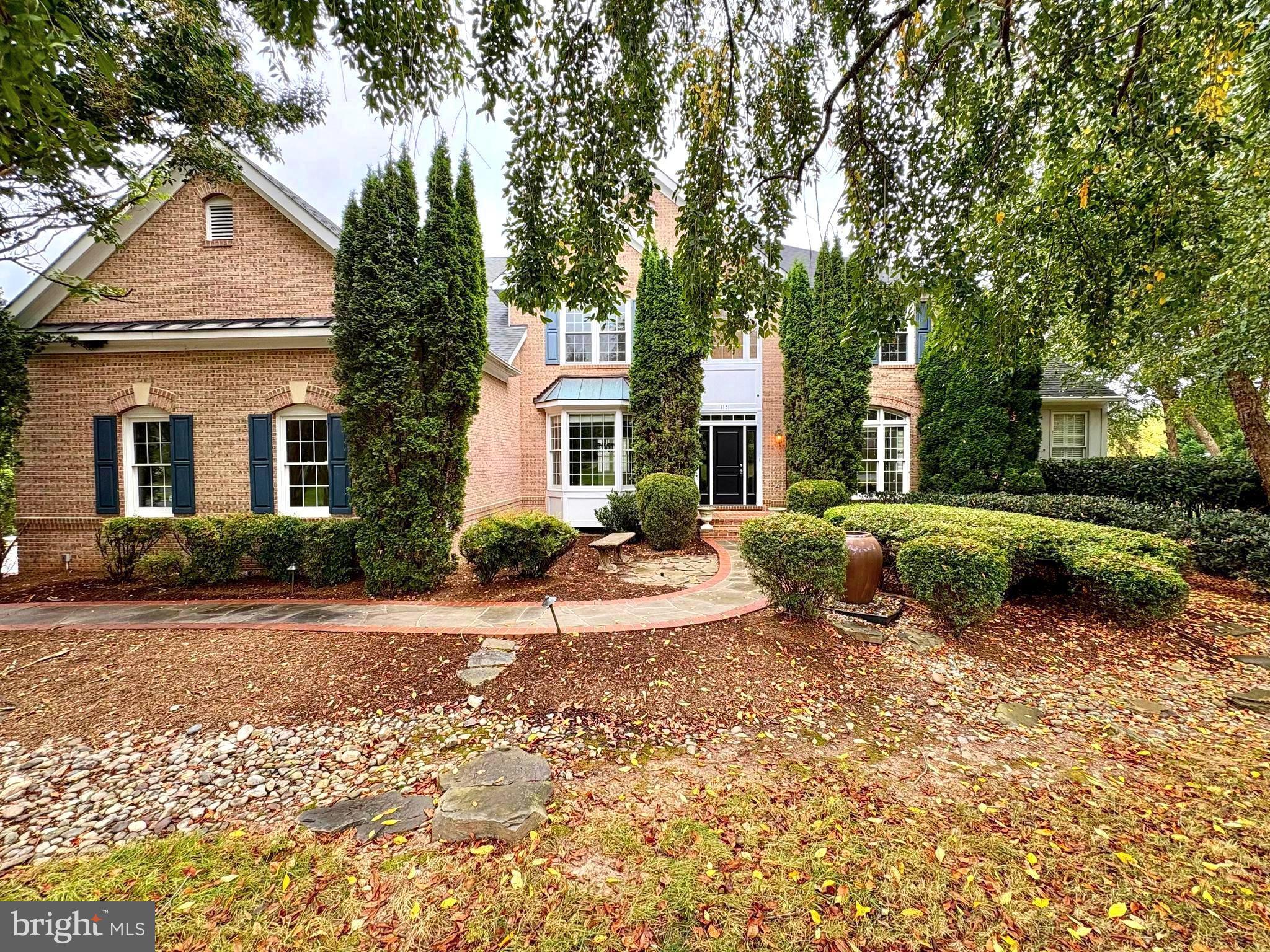 a view of a house with a patio and a yard
