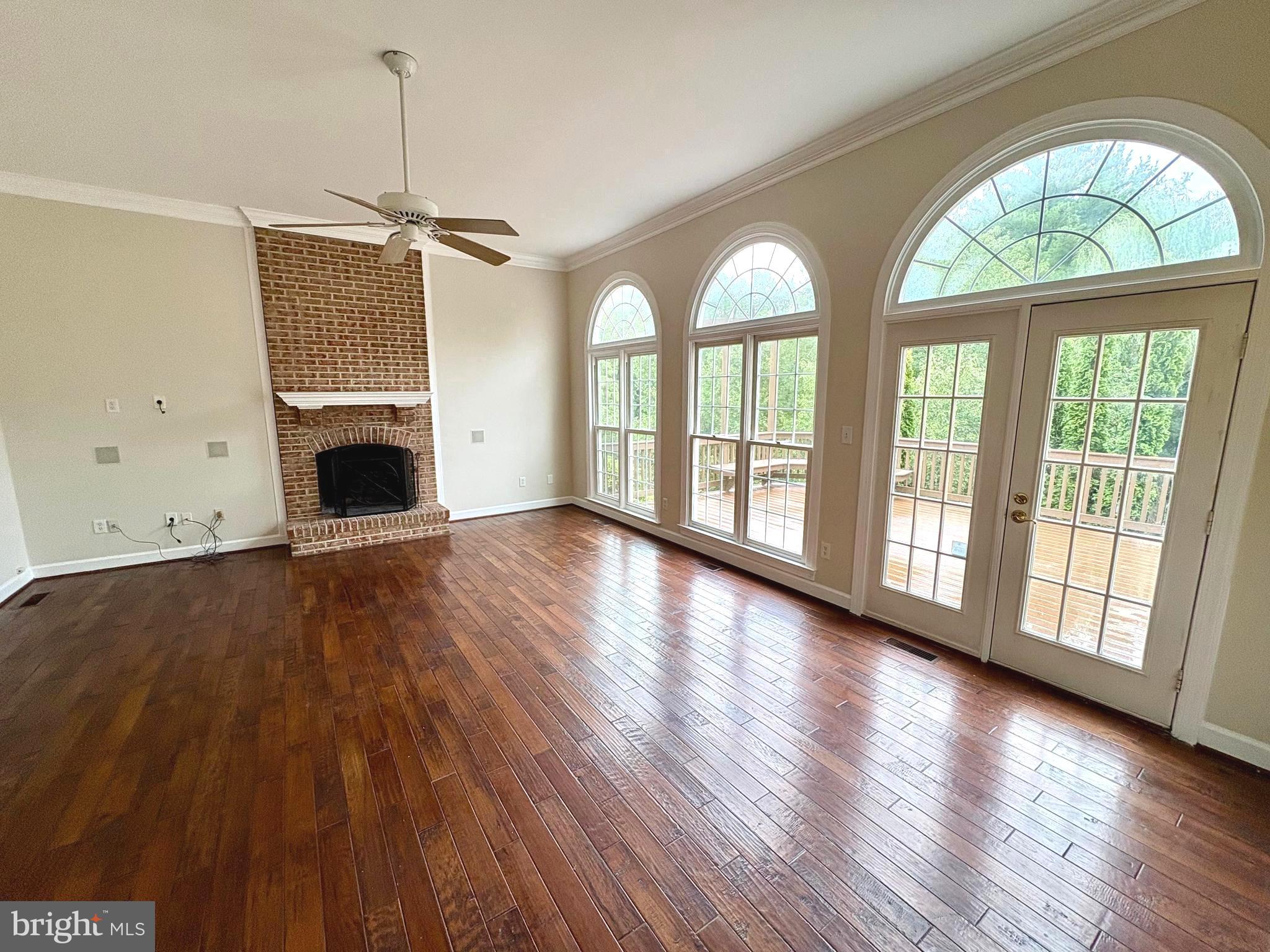 1151 Fieldview Drive Reston, VA 20194 - Photo 16 of 79 a view of an empty room with wooden floor a fireplace and a window