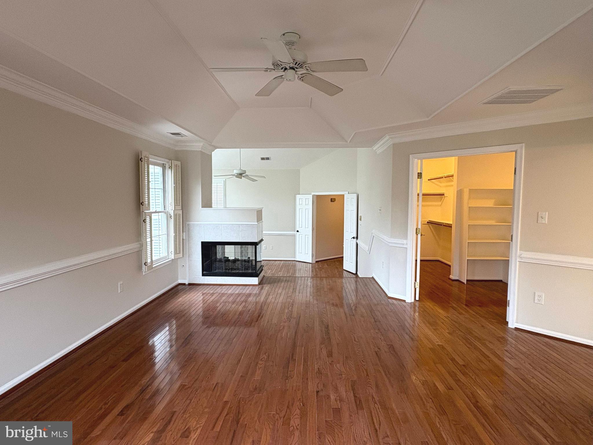 1151 Fieldview Drive Reston, VA 20194 - Photo 32 of 79 an empty room with wooden floor fireplace and windows