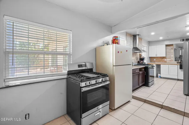 a living room with furniture a large window and a flat screen tv