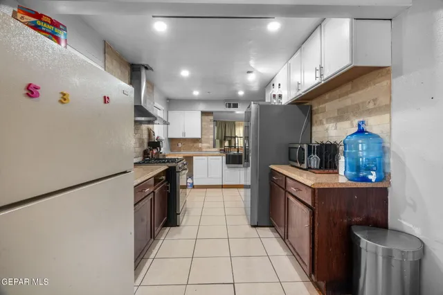 a living room with furniture and view of kitchen