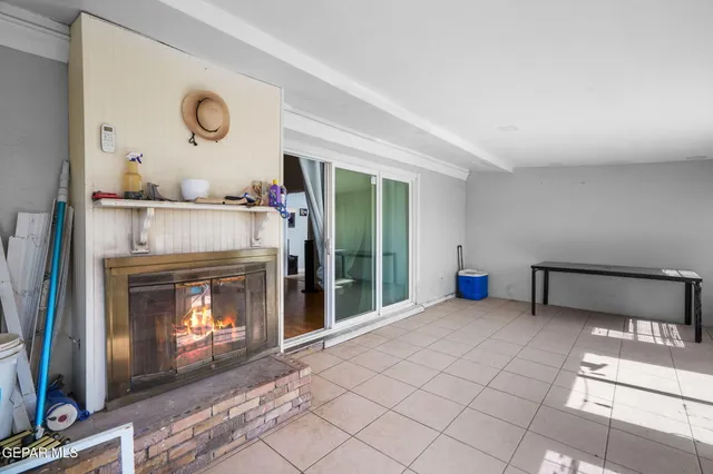 a bedroom with bed and a flat tv screen on dresser