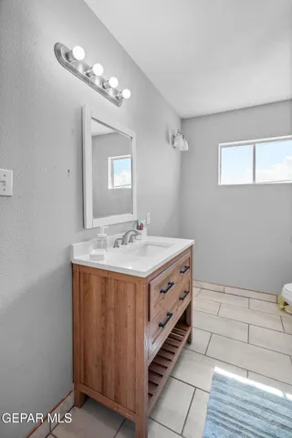 a living room with hard wood floors and a kitchen