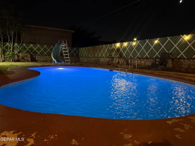 a view of a hallway with dining area and chandelier