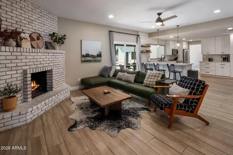 a living room with furniture or wooden floor and a fireplace