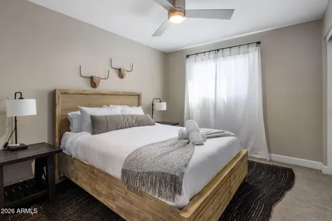 a bedroom with double bed and a window