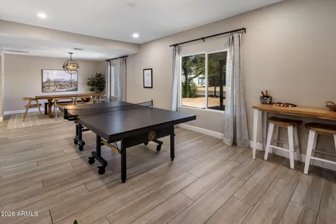 a view of a workspace with furniture window and wooden floor