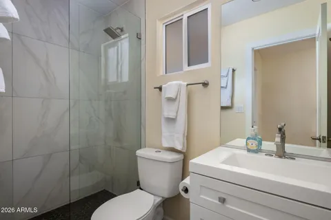 a bathroom with a sink toilet and shower