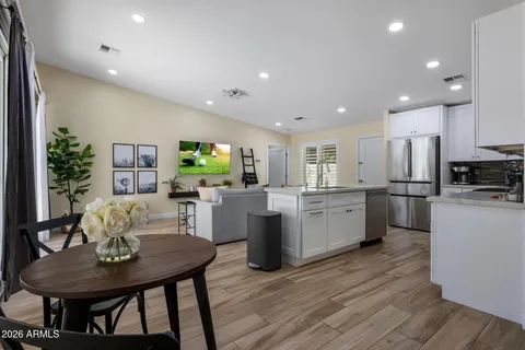 a kitchen with a table and chairs in it