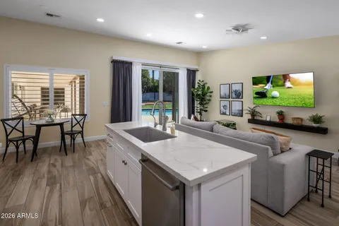 a living room with furniture a flat screen tv and a large window