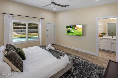 a bedroom with a bed and a flat screen tv