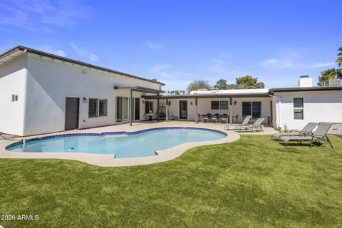 a view of an house with swimming pool and porch