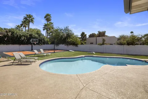a view of a swimming pool with lounge chairs