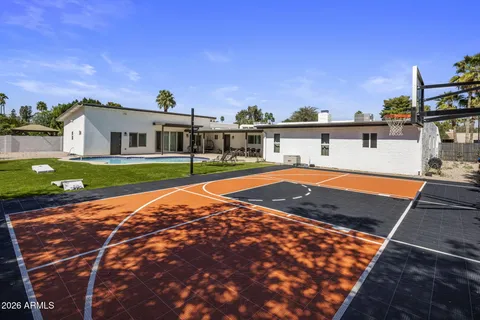 a view of a house with swimming pool and sitting area
