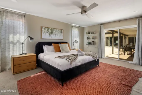 a bedroom with a large bed and a window