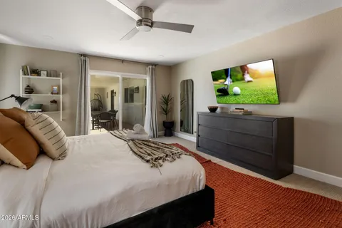 a bedroom with a bed and a flat screen tv