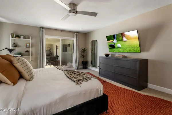 a bedroom with a bed and a flat screen tv