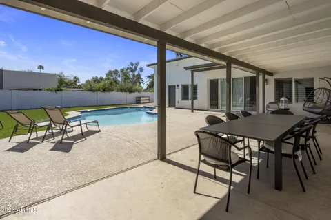 a view of a patio with a table and chairs