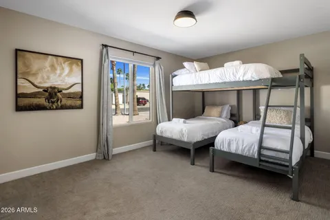 a bedroom with bed and wooden floor