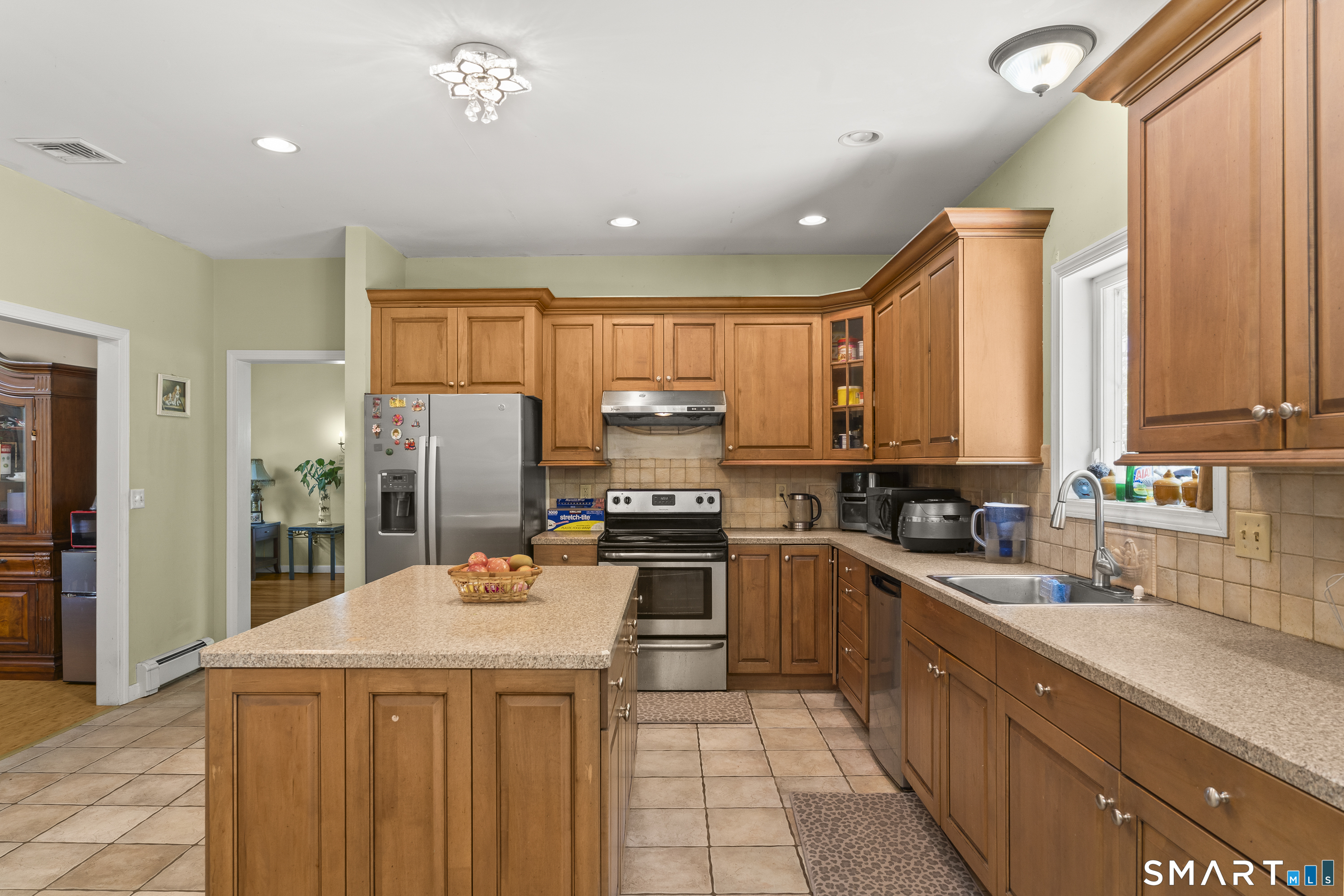 52 Middle Road Preston, CT 06365 - Photo 14 of 39 a kitchen with a stove a sink a refrigerator and cabinets