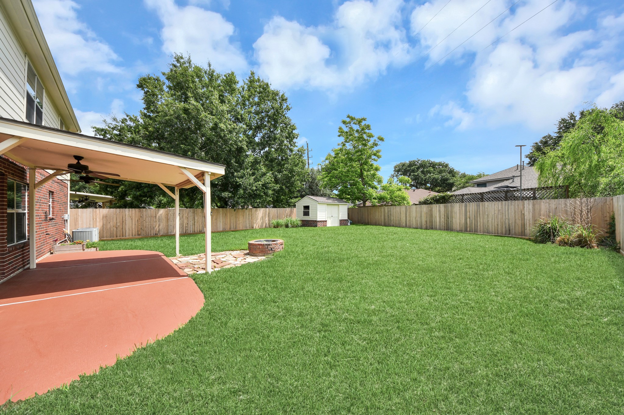 7622 McCormick Mill Court Houston, TX 77095 - Photo 33 of 37 a view of a backyard with grass & palm tree