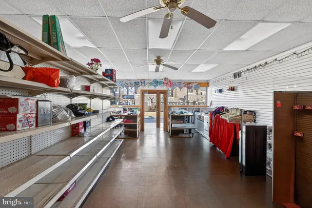 a room with a dining table chairs and white appliances