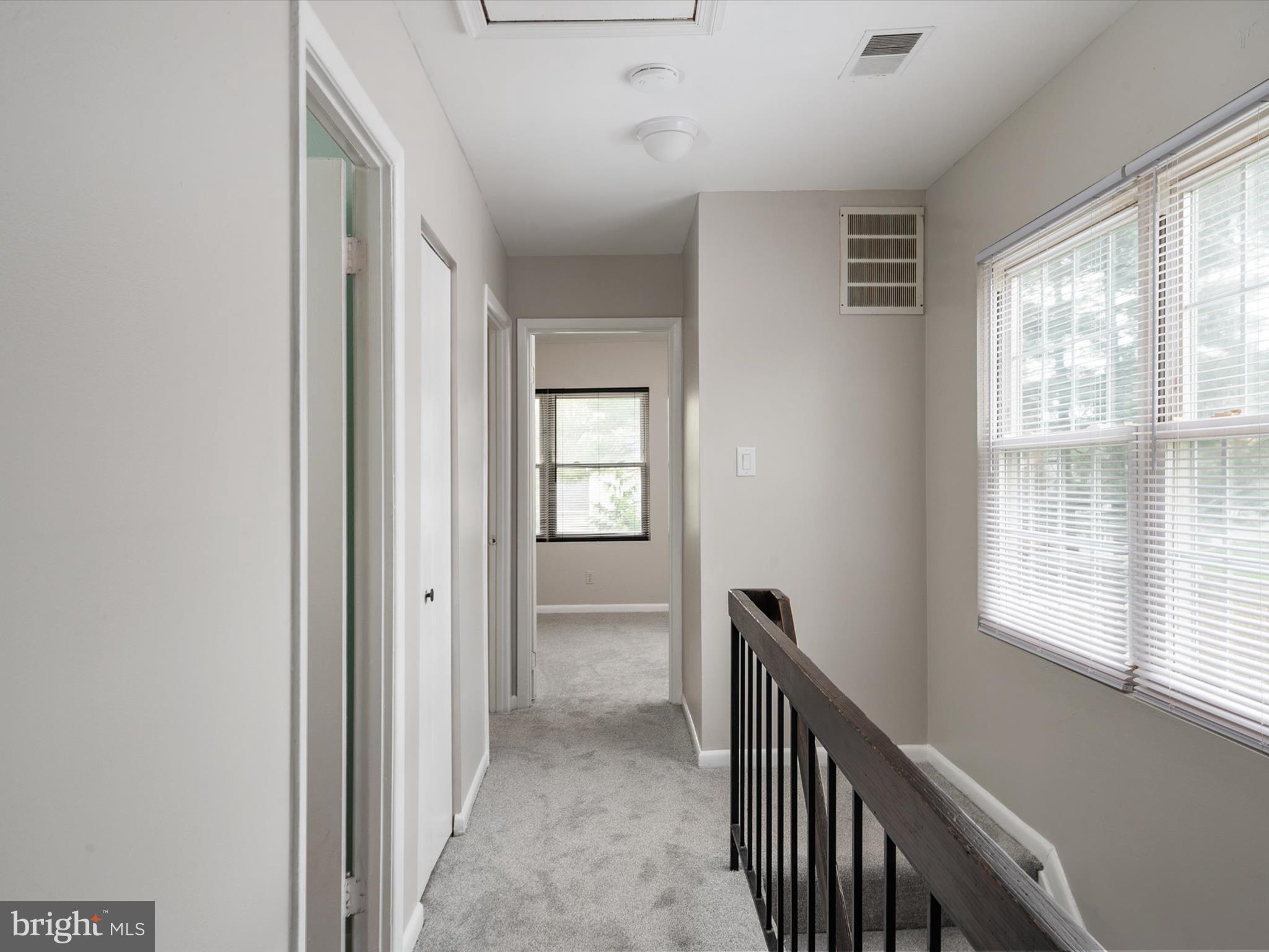 17422 Hoskinson Road Poolesville, MD 20837 - Photo 17 of 35 a view of a hallway with windows and stairs