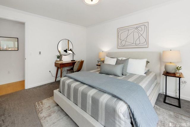 a bedroom with bed and night stand