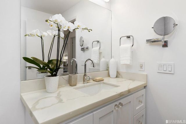 a bathroom with a sink a vanity and a mirror