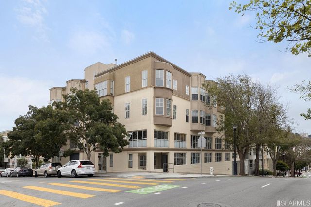 a view of a tall building next to a road