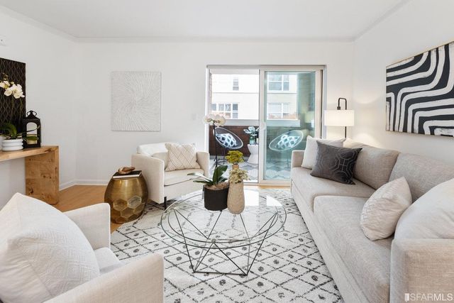 a living room with furniture and a floor to ceiling window