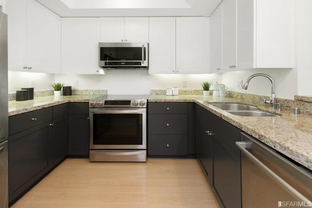 a kitchen with a sink and a stove top oven