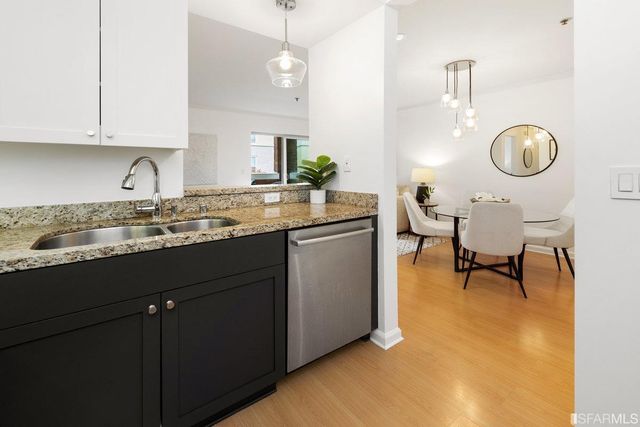 a kitchen with cabinets and chairs