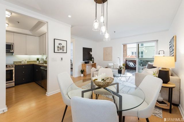 a living room with fireplace furniture and a chandelier