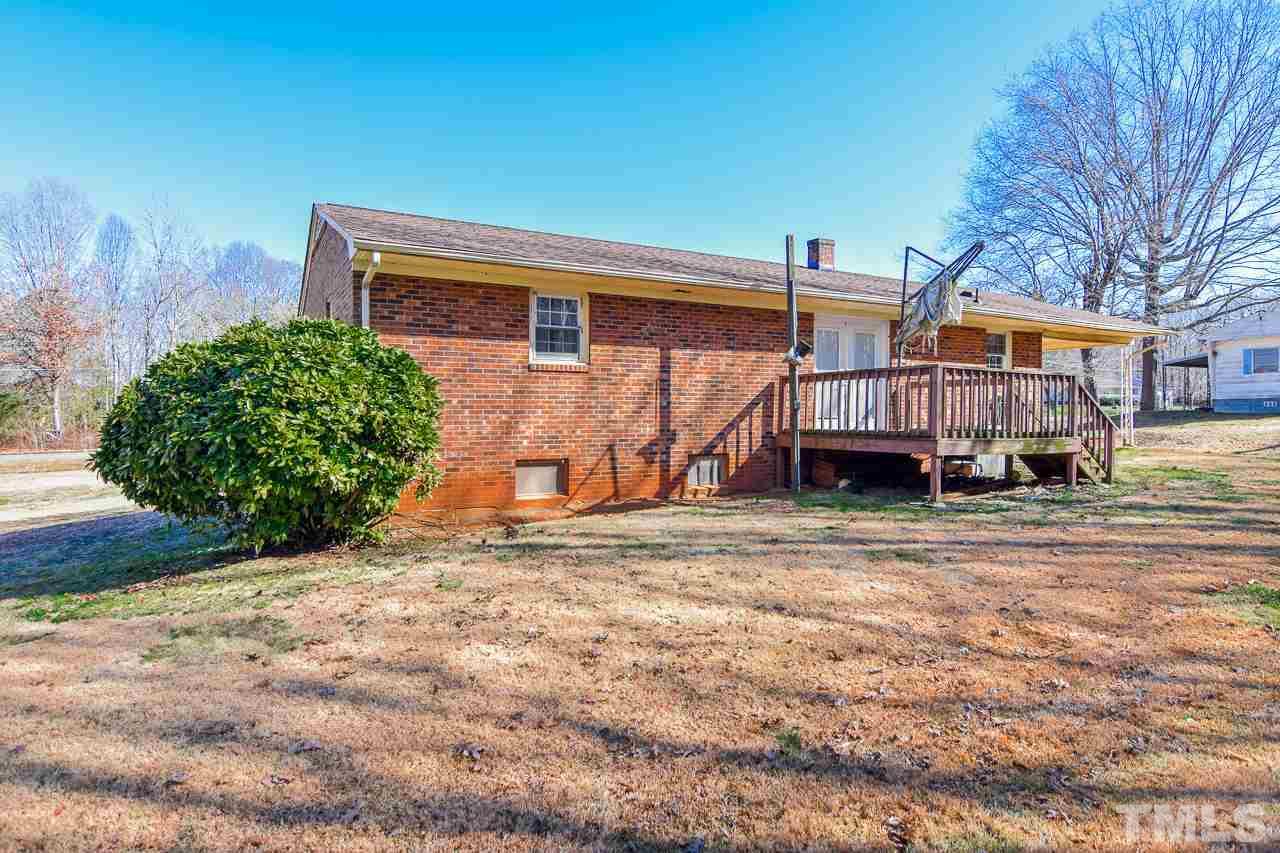 122 Henderson Road Roxboro, NC 27573 - Photo 11 of 27 a backyard of a house with barbeque oven and a stove