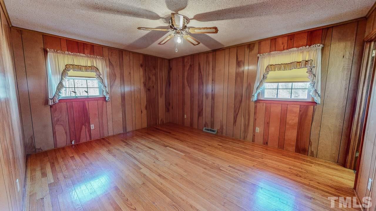 122 Henderson Road Roxboro, NC 27573 - Photo 15 of 27 wooden floor in an empty room with a window