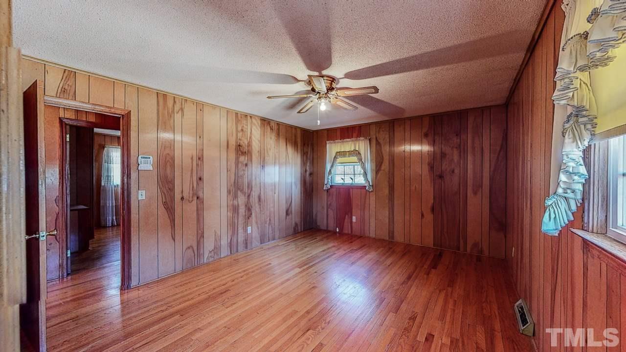 122 Henderson Road Roxboro, NC 27573 - Photo 16 of 27 wooden floor in an empty room with a window