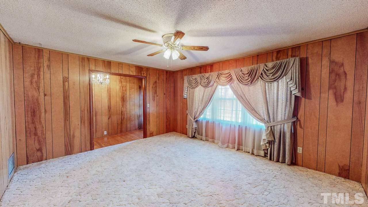 122 Henderson Road Roxboro, NC 27573 - Photo 10 of 27 a view of a livingroom with a fan and a window