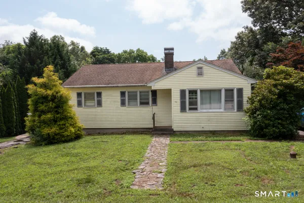 a front view of a house with a garden
