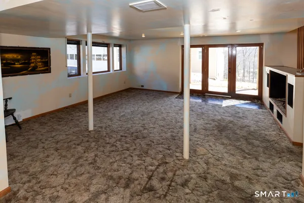 a view of work space with furniture and windows