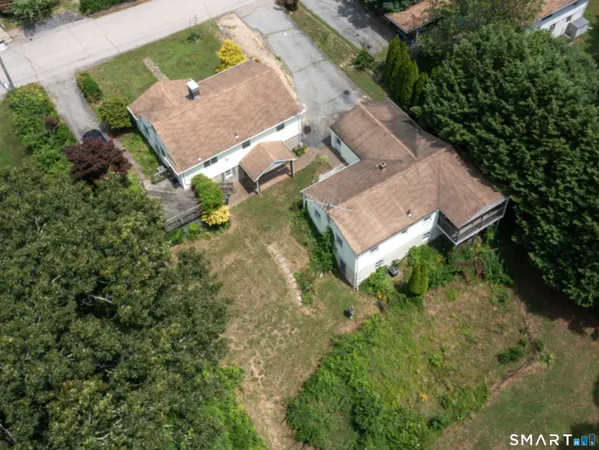 an aerial view of a house with a yard
