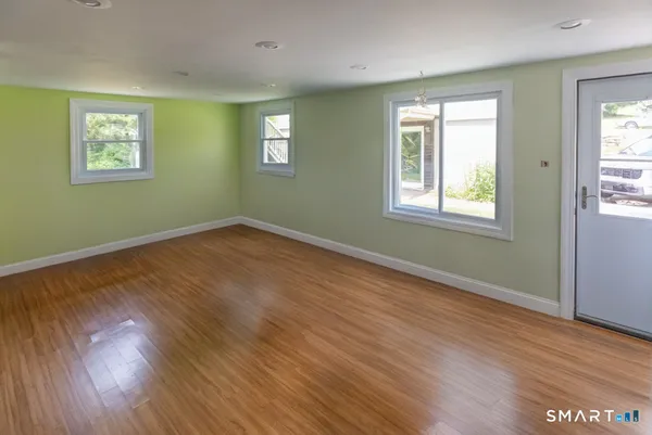 a view of an empty room with wooden floor